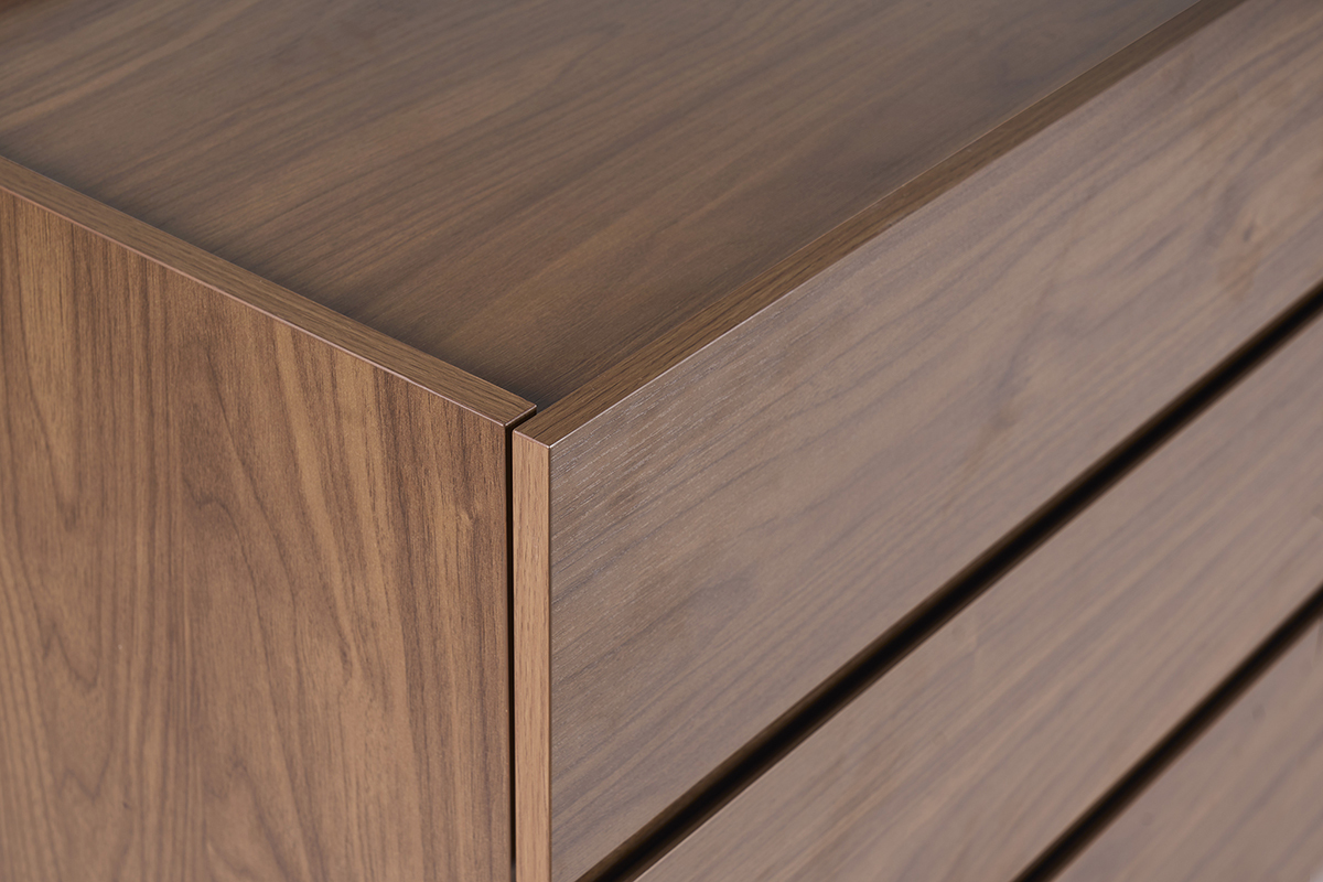 Vista de cerca de una c�moda de madera oscura de nogal con vetas visibles y bordes rectos.