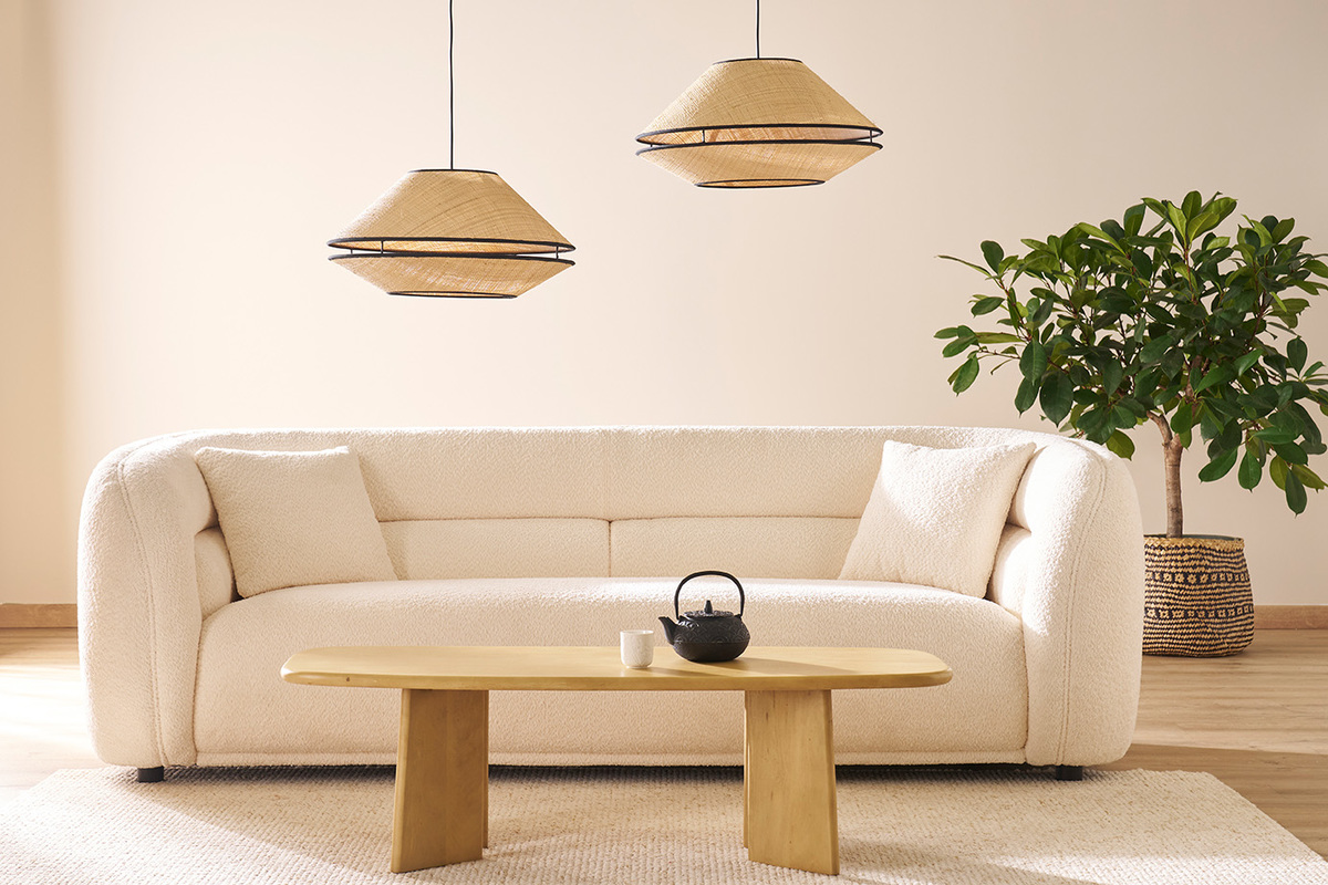 Mesa baja de madera maciza frente a un sof en una sala de estar moderna.