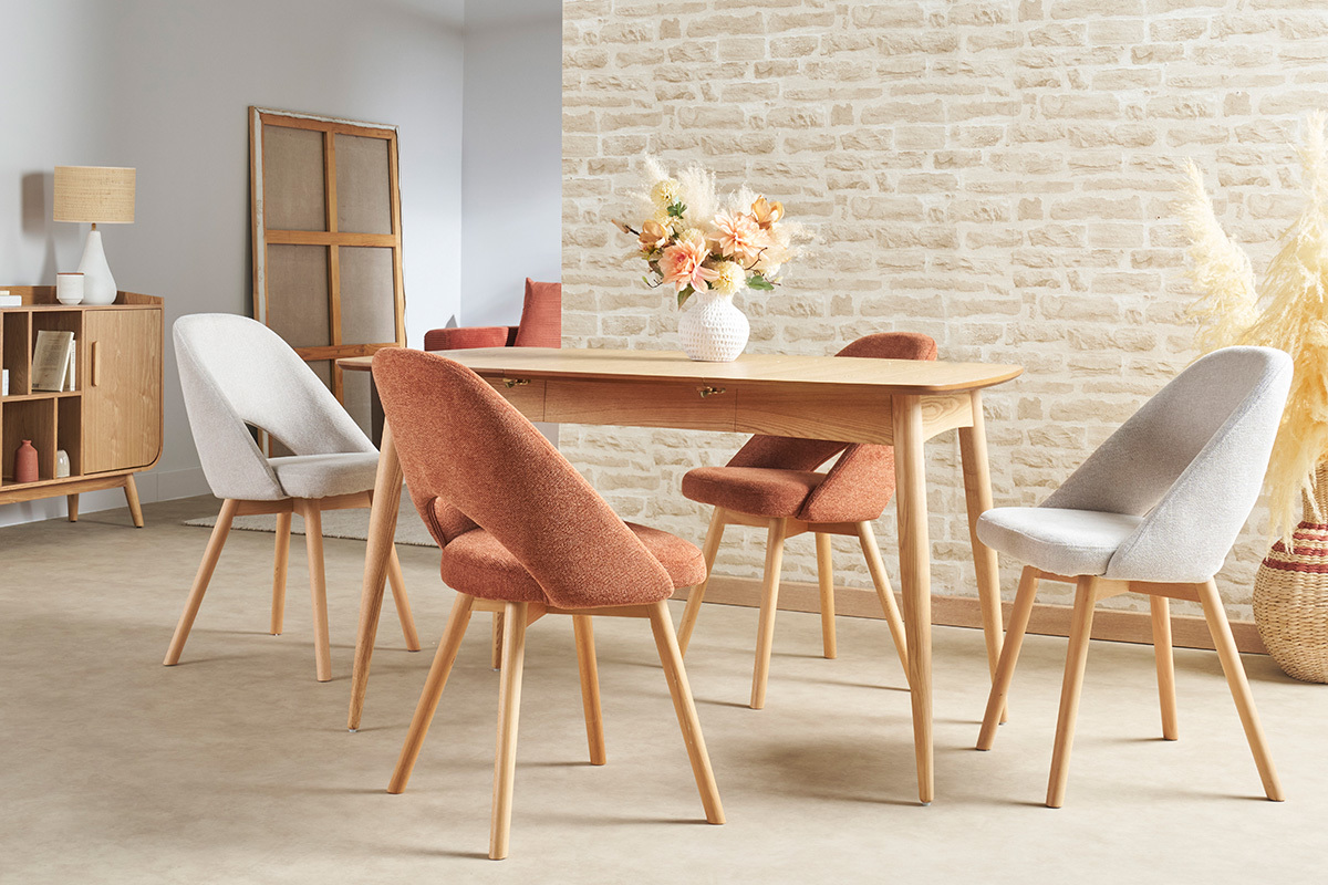 Sillas escandinavas de tela y madera clara, presentadas alrededor de una mesa de madera.