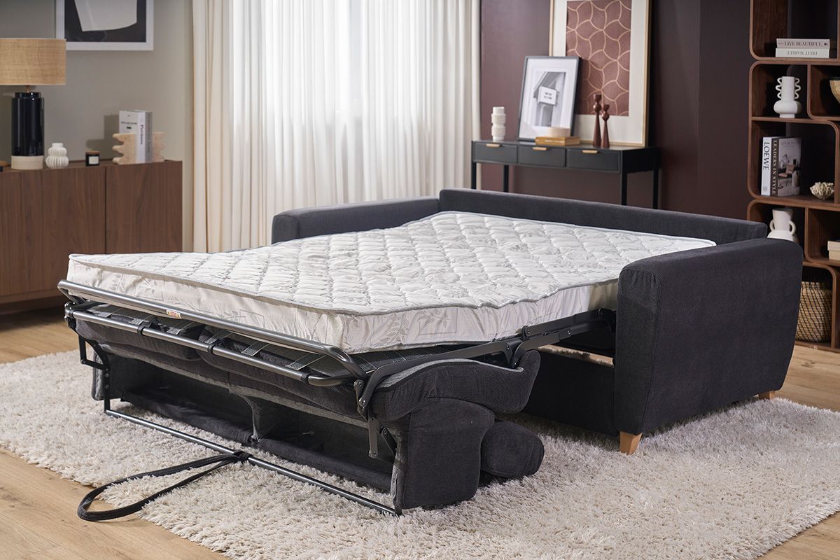 Canap� convertible gris anthracita con colch�n abierto, vista lateral, reposacabezas ajustables.