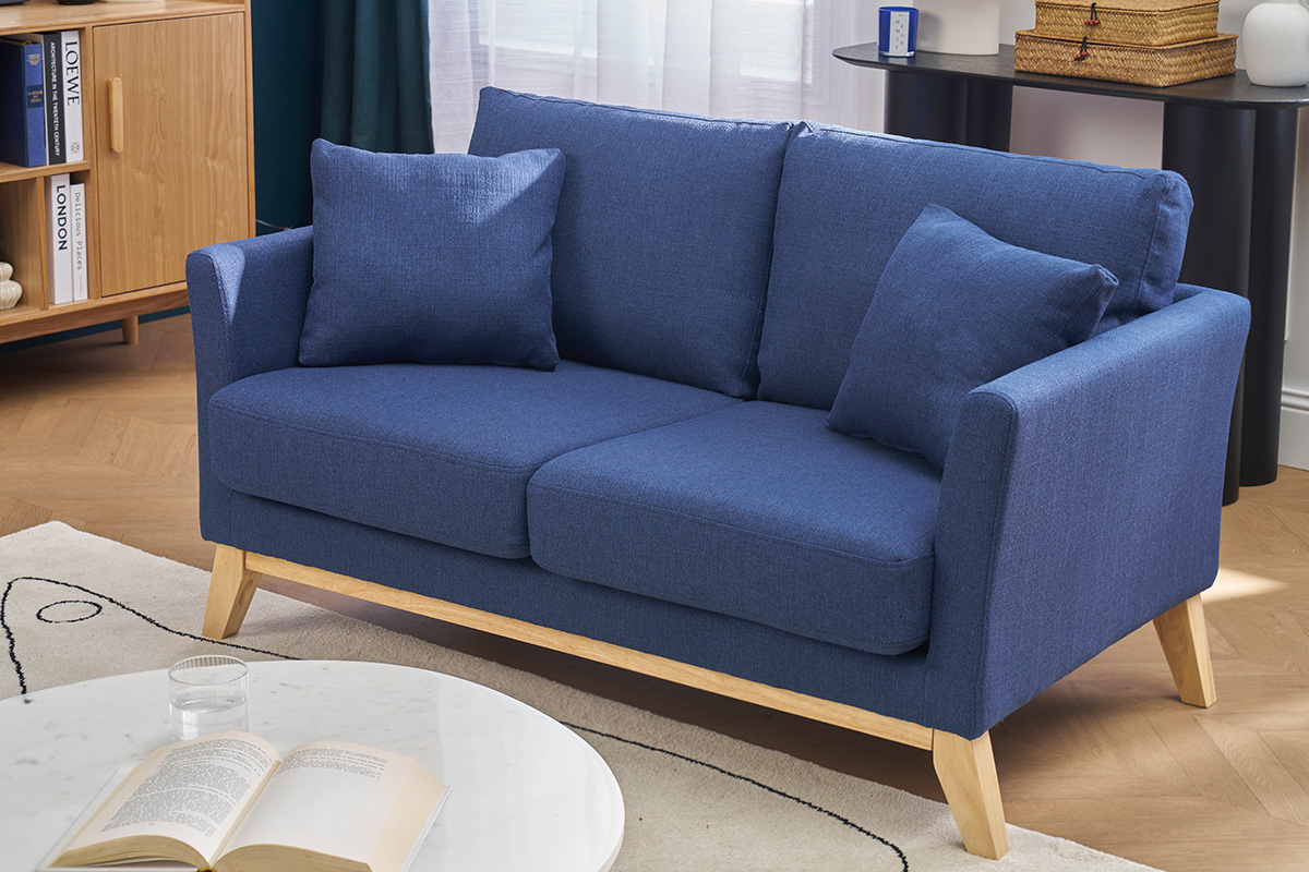 Sof� escandinavo azul oscuro de dos plazas con patas de madera clara, vista frontal.